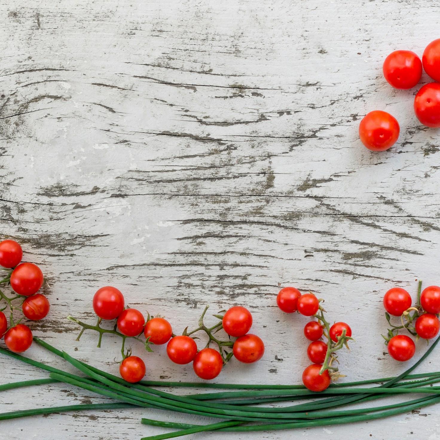 Community members collaborating in a contemporary kitchen space, exchanging recipes and cooking techniques